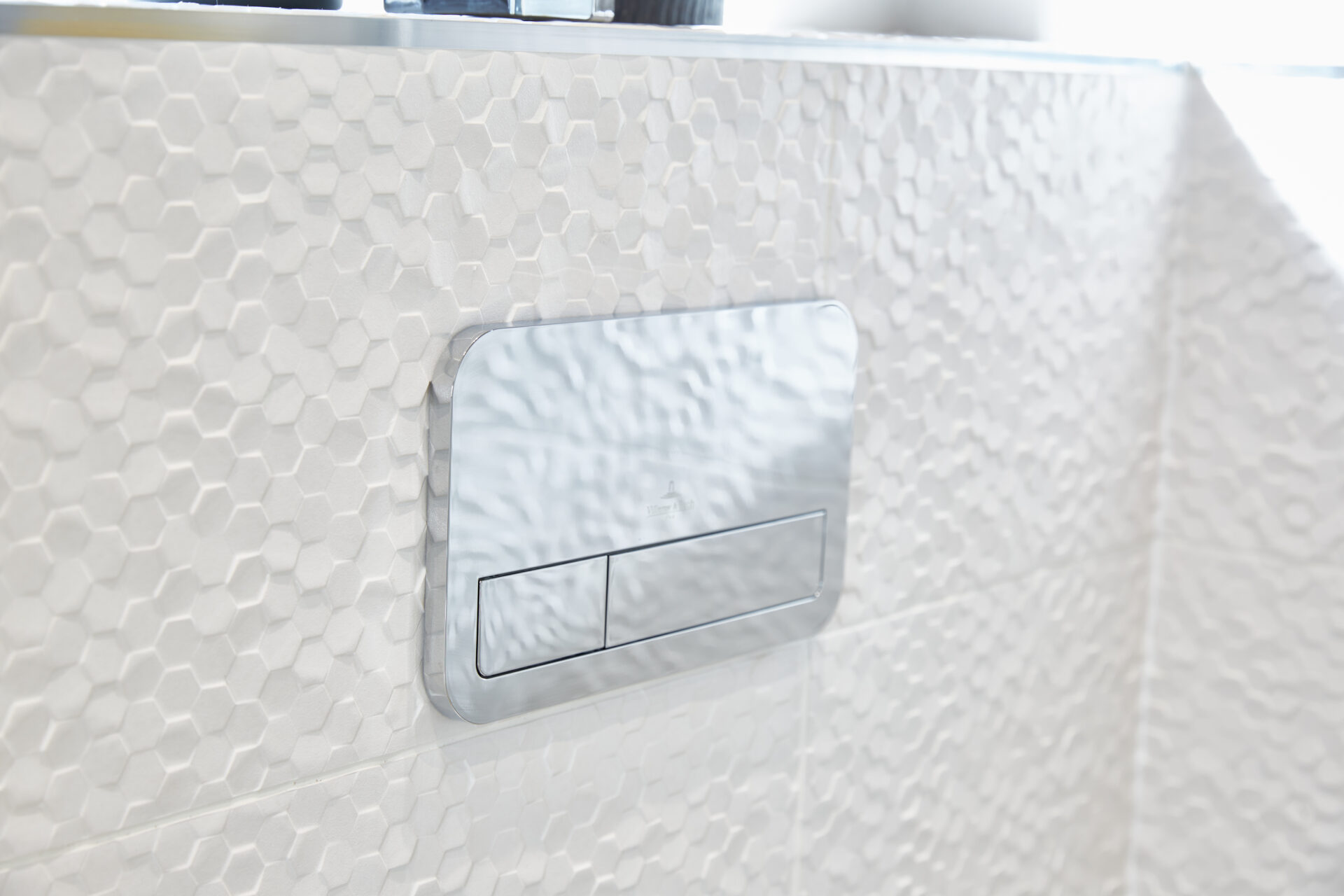 Porcelanosa tiling and V&B flush plate